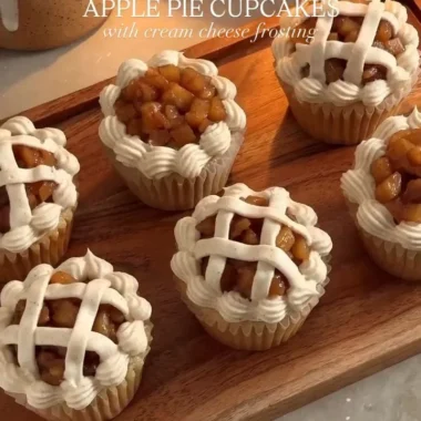 Delicious apple pie cupcakes topped with cream and apple slices