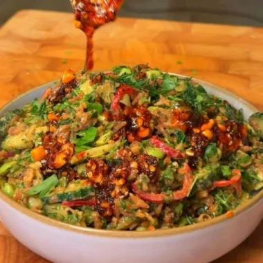 Delicious crispy rice salad topped with fresh vegetables and herbs.