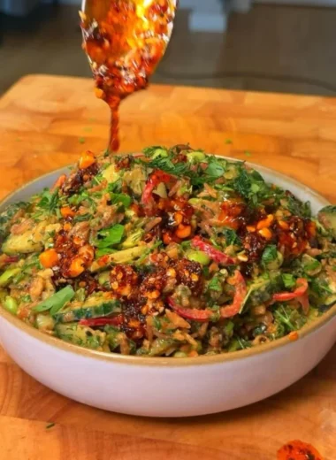 Delicious crispy rice salad topped with fresh vegetables and herbs.