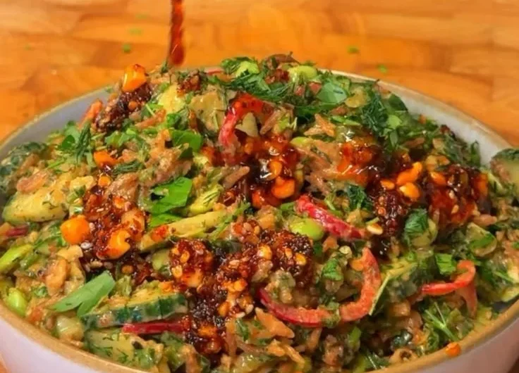 Delicious crispy rice salad topped with fresh vegetables and herbs.