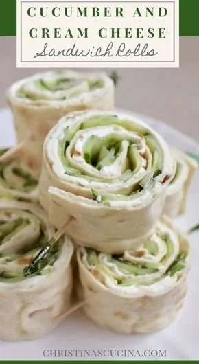 Cucumber and cream cheese sandwich rolls on a platter
