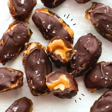 A plate of homemade Date Snickers bars, a healthy dessert alternative.