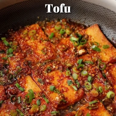 Close-up of Korean braised tofu in a savory sauce with vegetables.