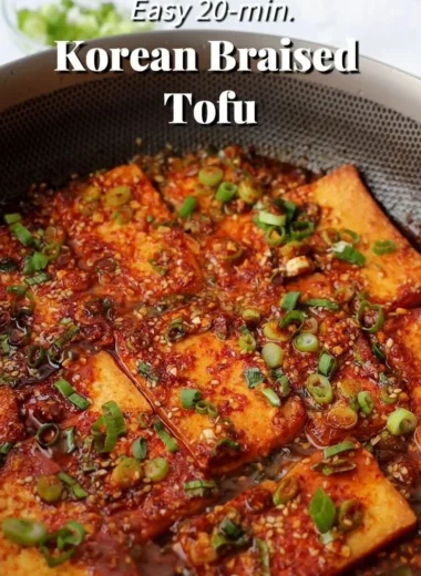 Close-up of Korean braised tofu in a savory sauce with vegetables.