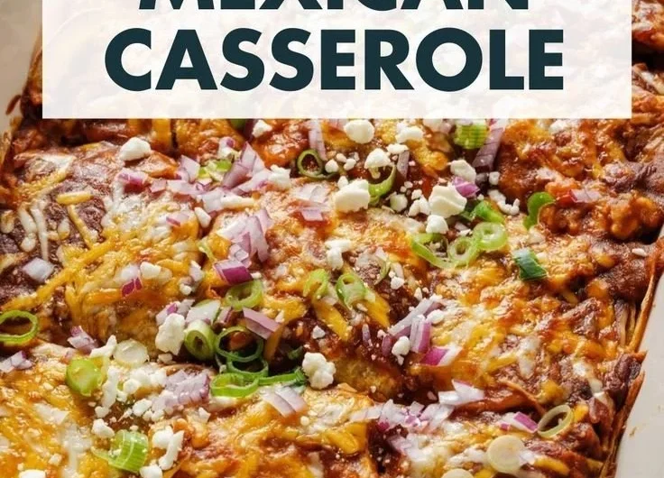 Delicious vegetarian enchilada casserole topped with cheese and fresh herbs.