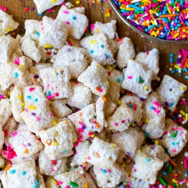 Delicious Cake Batter Puppy Chow dessert in a bowl, perfect for snacking.