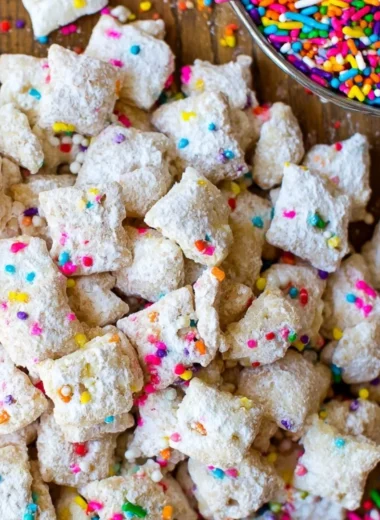 Delicious Cake Batter Puppy Chow dessert in a bowl, perfect for snacking.