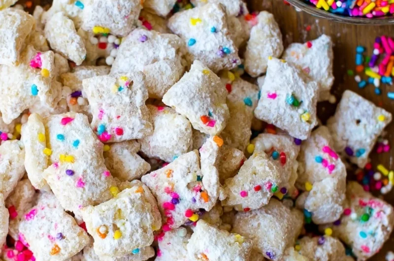 Delicious Cake Batter Puppy Chow dessert in a bowl, perfect for snacking.