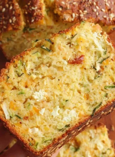 Cheesy zucchini bread fresh out of the oven, golden brown and fluffy.