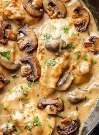 Delicious chicken skillet with mushrooms cooked in a frying pan