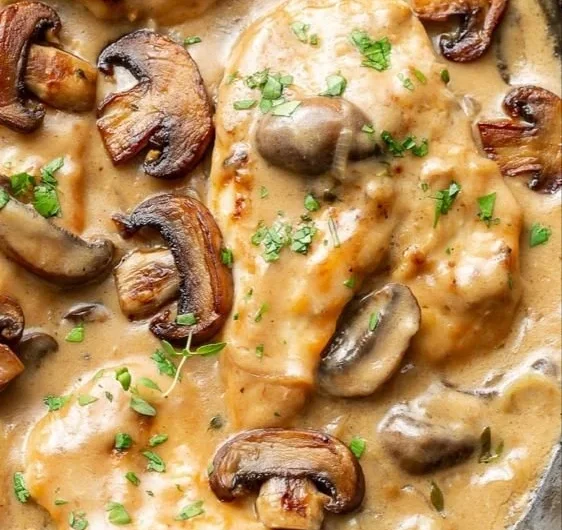 Delicious chicken skillet with mushrooms cooked in a frying pan