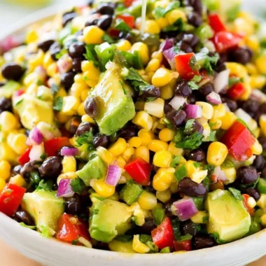 Bowl of homemade Cowboy Caviar dip with colorful vegetables and beans.
