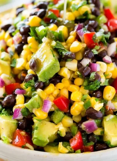 Bowl of homemade Cowboy Caviar dip with colorful vegetables and beans.