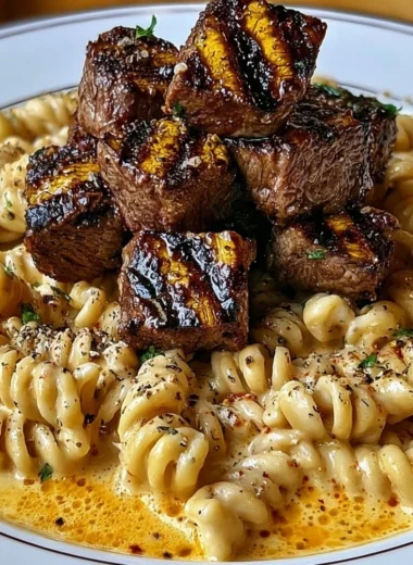 Creamy garlic butter steak bites served with spicy Cajun Alfredo twisted pasta.