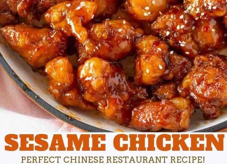 Delicious crispy sesame chicken garnished with sesame seeds and green onions