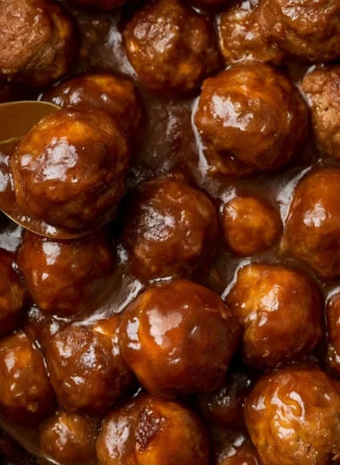 Slow cooker Salisbury steak meatballs served with creamy gravy and herbs