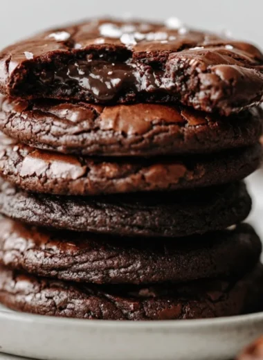 Fudgy brownie cookies with chocolate chunks on a baking sheet.