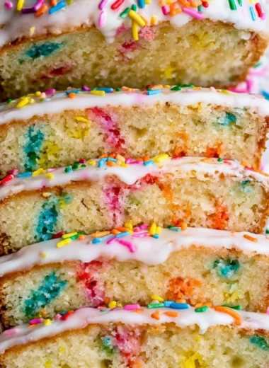 A beautifully baked Funfetti Pound Cake topped with colorful sprinkles.