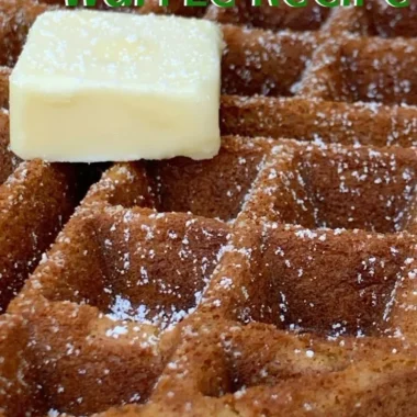 Fluffy gingerbread waffles topped with whipped cream and spices.