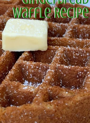 Fluffy gingerbread waffles topped with whipped cream and spices.