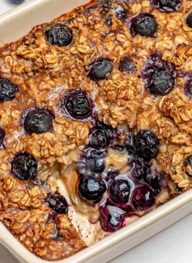 Healthy blueberry baked oatmeal topped with fresh blueberries and nuts