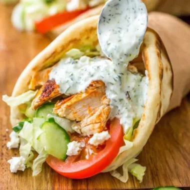 Delicious homemade chicken gyro served with fresh vegetables and tzatziki sauce.