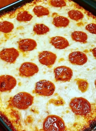 Keto Pizza Casserole topped with cheese and fresh ingredients