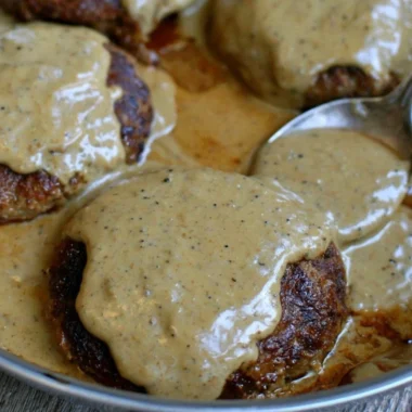 Delicious homemade hamburger steak served with creamy gravy.