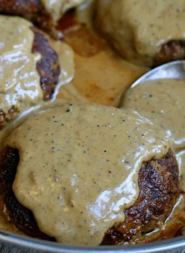 Delicious homemade hamburger steak served with creamy gravy.