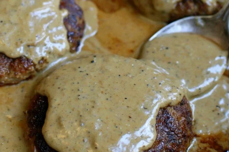 Delicious homemade hamburger steak served with creamy gravy.