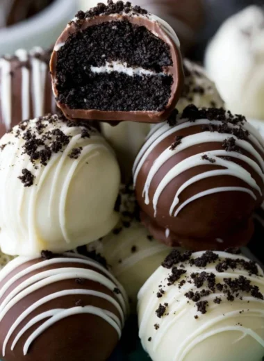 Homemade Oreo Truffles dipped in chocolate and decorated with Oreo crumbs