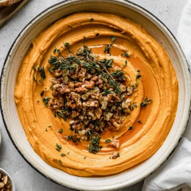 Creamy Pumpkin Whipped Feta garnished with herbs
