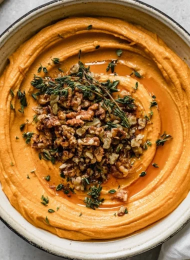 Creamy Pumpkin Whipped Feta garnished with herbs