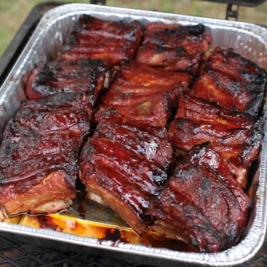 Deliciously grilled ribs served with BBQ sauce and sides.