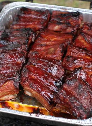 Deliciously grilled ribs served with BBQ sauce and sides.