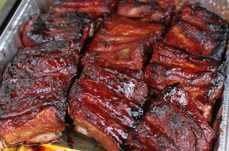 Deliciously grilled ribs served with BBQ sauce and sides.
