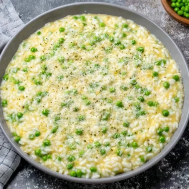 A plate of Rice and Peas served with fresh herbs and spices, showcasing its vibrant colors.