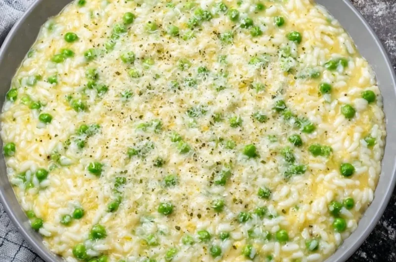 A plate of Rice and Peas served with fresh herbs and spices, showcasing its vibrant colors.
