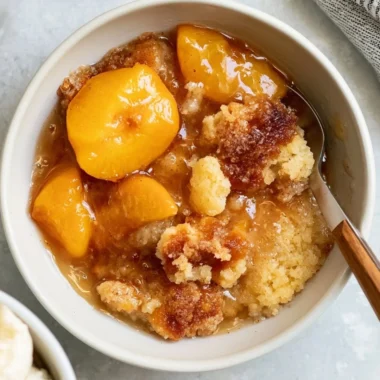 Delicious Southern peach cobbler dessert served warm with ice cream