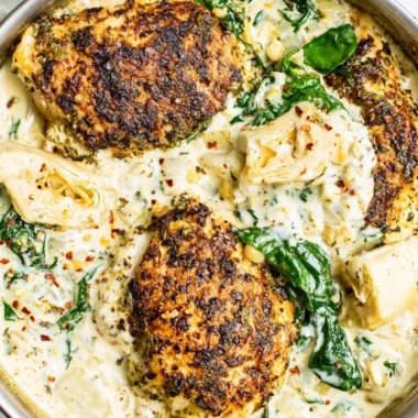 Delicious Spinach Artichoke Chicken Skillet served in a cast iron pan