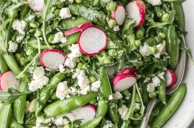 Vibrant Sugar Snap Pea Salad topped with fresh vegetables and dressing