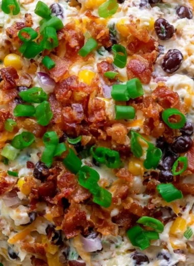 Delicious cowboy corn dip served in a bowl, garnished with fresh herbs.