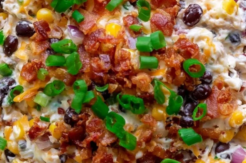 Delicious cowboy corn dip served in a bowl, garnished with fresh herbs.