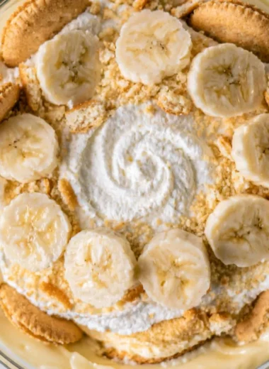Delicious cozy homemade banana pudding in a glass bowl with whipped cream topping