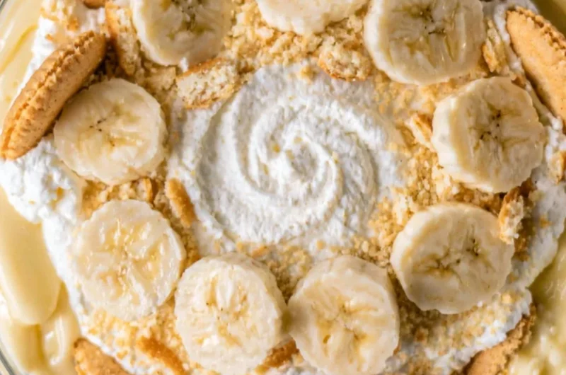 Delicious cozy homemade banana pudding in a glass bowl with whipped cream topping