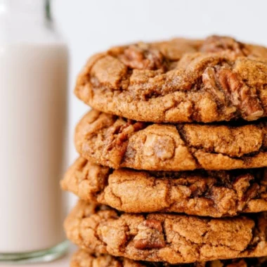 Cozy maple pecan cookies fresh out of the oven on a rustic wooden table.