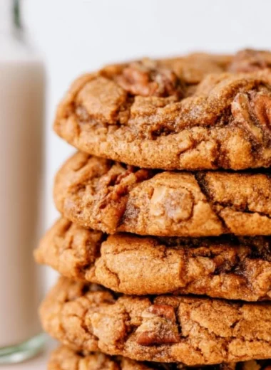Cozy maple pecan cookies fresh out of the oven on a rustic wooden table.