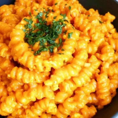Bowl of Gochujang Pasta garnished with vegetables and herbs