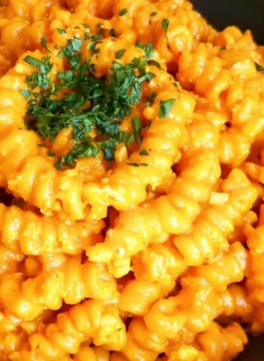 Bowl of Gochujang Pasta garnished with vegetables and herbs