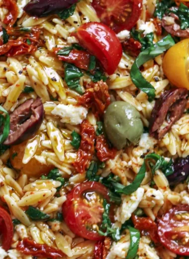 Greek Orzo salad with tomatoes, olives, basil, and feta cheese.